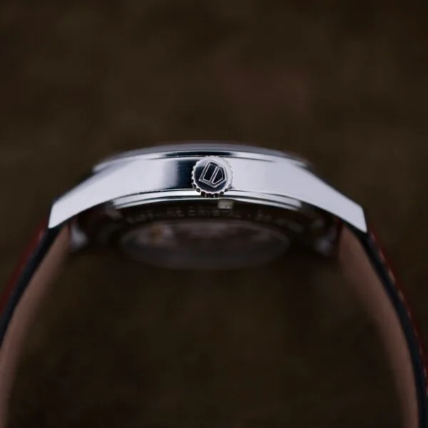 Close-up of the Tag Heuer Carrera Caliber 5 Automatic Wv211A.Fc6203, featuring a vintage silver round case and right-side crown. The classic leather strap watch is set against a dark background.