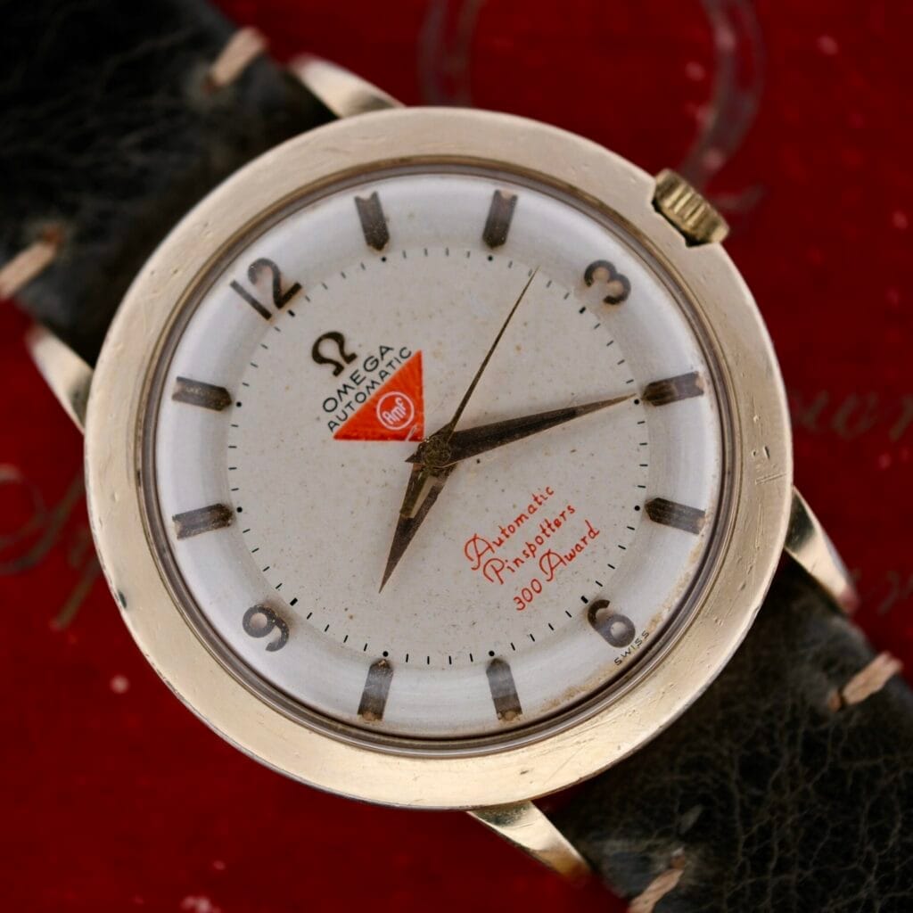 Close-up of the Omega Pinpointers 300 Game Dial Wristwatch Automatic, featuring a white dial with black numbers and a black leather strap.