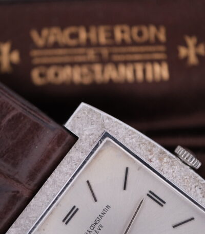 Introducing the Vacheron Constantin 6761, a timeless masterpiece from the prestigious Swiss watchmaker, crafted between 1970 and 1979. This exquisite timepiece features a sleek 27mm case made from luxurious 18K white gold, exuding elegance and sophistication. The watch is powered by the renowned Caliber 1003 manual wind movement, a testament to Vacheron Constantin's commitment to precision and craftsmanship. The dial is a pristine white, complemented by silver-tone hands and markers, creating a harmonious and refined aesthetic. The watch is paired with a high-quality leather strap, measuring 18mm in width, ensuring both comfort and style on the wrist. This Vacheron Constantin 6761 comes complete with its original box, adding to its collectible value and making it a perfect gift for connoisseurs of fine horology. Embrace the legacy of Swiss watchmaking with this exceptional piece, a true symbol of luxury and enduring elegance.