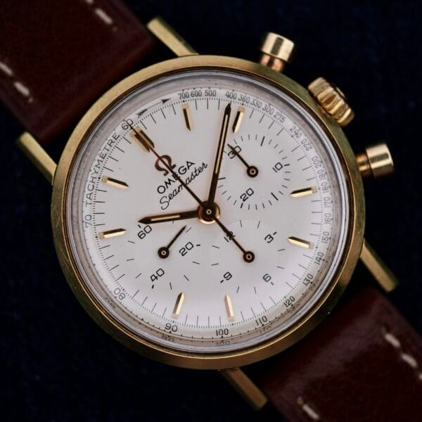 Omega Seamaster Chronograph Ref. 105.005 with 321 Caliber, featuring a white dial and brown leather strap, shown in a close-up photo.