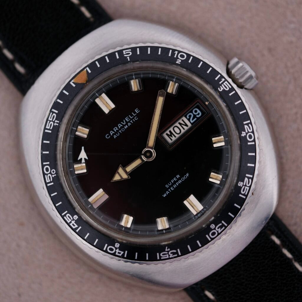 A Caravelle Automatic Ref 745 Diver “Jet Seconds” Super Waterproof wristwatch displaying the day and date as MON 29, with a black face and silver bezel.