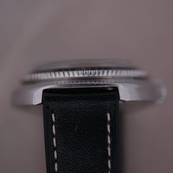 Close-up side view of a Caravelle Automatic Ref 745 Diver “Jet Seconds” Super Waterproof watch with a black leather strap, showcasing the textured bezel and precise craftsmanship at the strap and case connection.