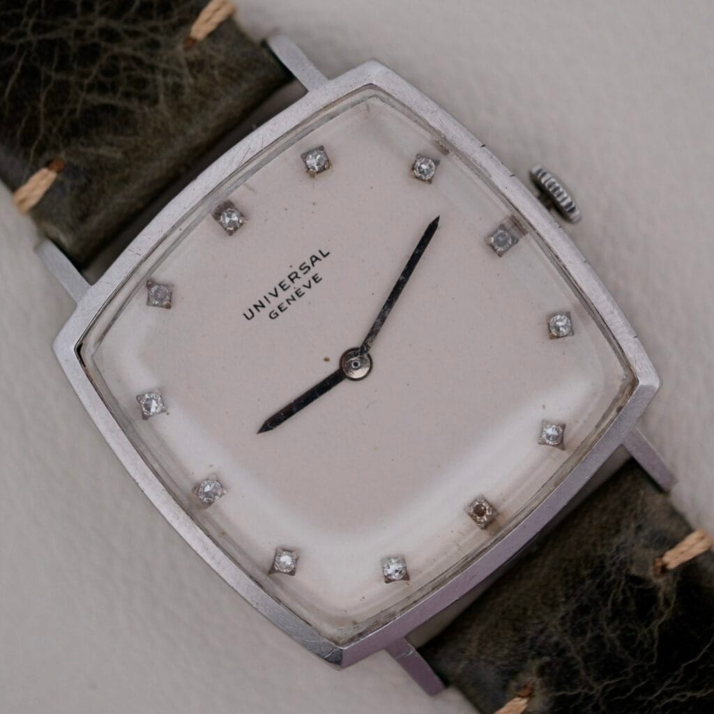 Universal Geneve White Diamond Dial Micro-Rotor Cal. 66, square case, white dial with diamond markers, and a worn black leather strap featuring the esteemed micro-rotor movement.