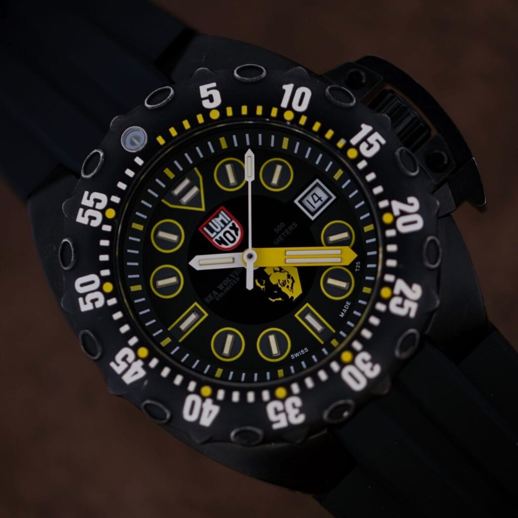 Luminox Scott Cassell Deep Dive Specia 1526 Automatic wristwatch features a black case with yellow accents, bold numerals, and a black rubber strap, displayed against a dark background.