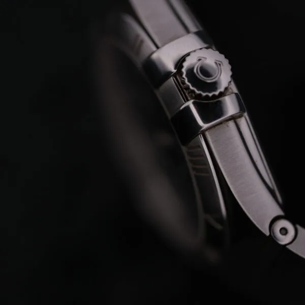 Close-up of the Omega Constellation Ref. 396.201, set against a dark background, with focus on its polished metal strap and intricately designed crown.