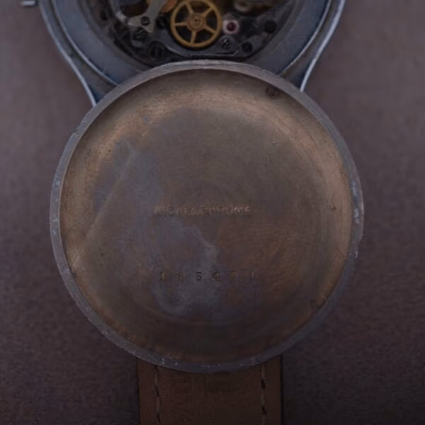 Inner caseback of Cervus chronograph stamped NICKEL CHROME with six-digit case serial number and glimpse of movement above