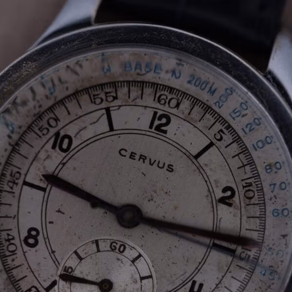 Macro close-up of Cervus chronograph dial showing crisp CERVUS signature, twelve and two numerals, and blue printed base-200m scale