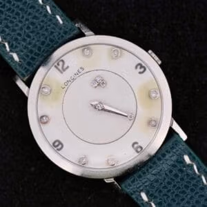 Front view of the 1958 Longines Mystery Dial in 14k white gold showing eight diamond markers, Arabic 12/3/6/9, and sunburst center