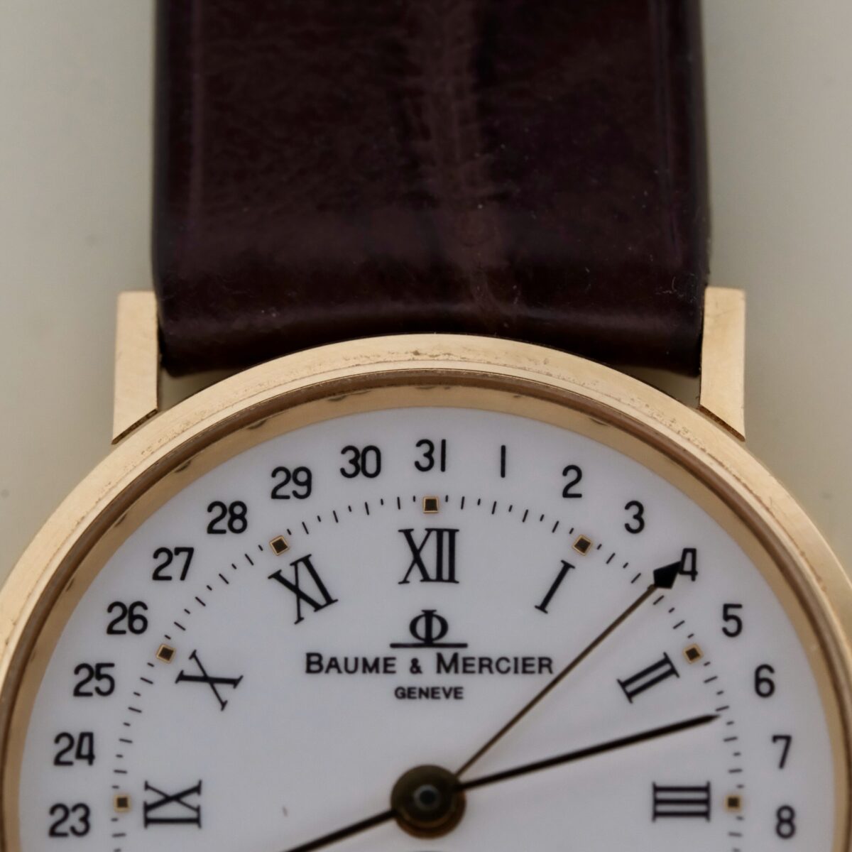 The Baume & Mercier 18k Gold Calendar Ref 15162 is a Swiss-made, 1990s timepiece featuring a 30mm 18k yellow gold case and a white dial with gold-tone markers and hands. It operates on a quartz movement, offering reliable timekeeping with a date function, small seconds sub-dial, and hack second feature. The watch is paired with a high-quality leather strap, ensuring comfort and durability. While not a chronometer, it exemplifies Baume & Mercier's exceptional craftsmanship, making it a sophisticated choice for collectors and enthusiasts.