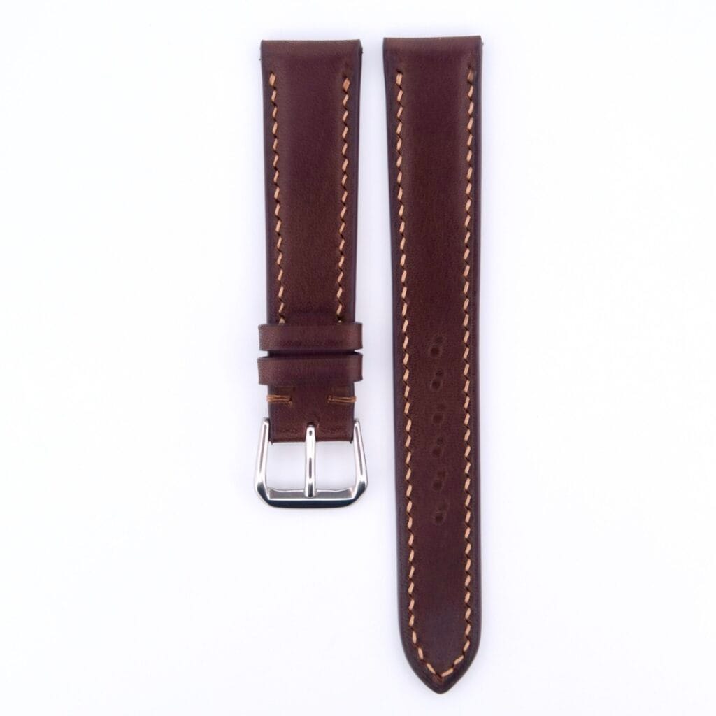A Dark Brown Genuine Horween Shell Cordovan Watch Strap in vintage style, featuring beige stitching. It is shown in two pieces on a white background; the left has a silver buckle, and the right displays three adjustment holes.