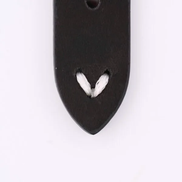Close-up of a dark-colored Vintage Calf Leather Watch Strap Single End Stitch, featuring two small slits with a white cord looped through. Set against a plain white background, it exudes timeless elegance.