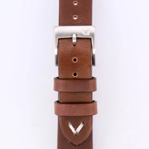 Close-up of the Vintage Calf Leather Watch Strap Single End Stitch, crafted from brown leather with a silver buckle. It offers multiple adjustment holes and two loops for securing excess length, embodying timeless elegance.