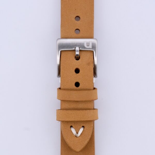 Close-up of the Vintage Calf Leather Watch Strap Single End Stitch in tan leather with a silver buckle, featuring multiple adjustment holes and a pointed end secured by a loop, all set against a plain white background.
