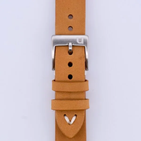 Close-up of the Vintage Calf Leather Watch Strap Single End Stitch in tan leather with a silver buckle, featuring multiple adjustment holes and a pointed end secured by a loop, all set against a plain white background.