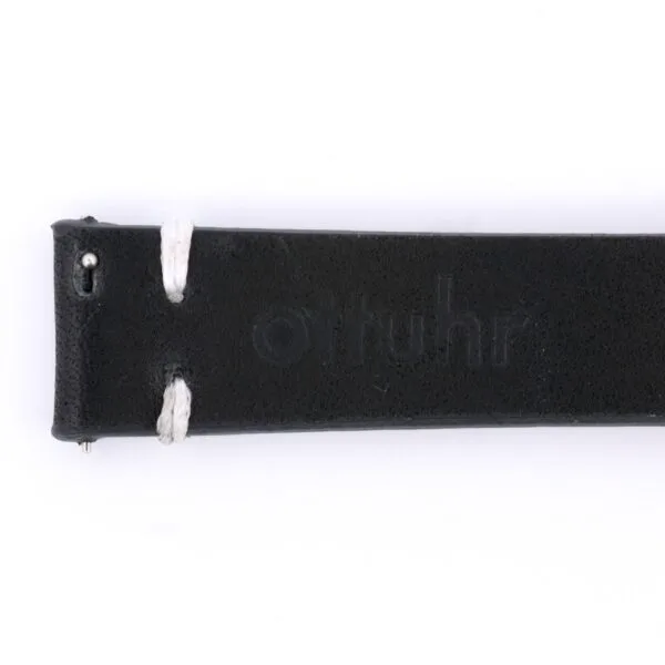 Close-up of the Vintage Calf Leather Watch Strap Single End Stitch in black leather with white stitching and otuhr embossed, exuding a vintage watch aesthetic. The strap is displayed horizontally against a crisp white background.