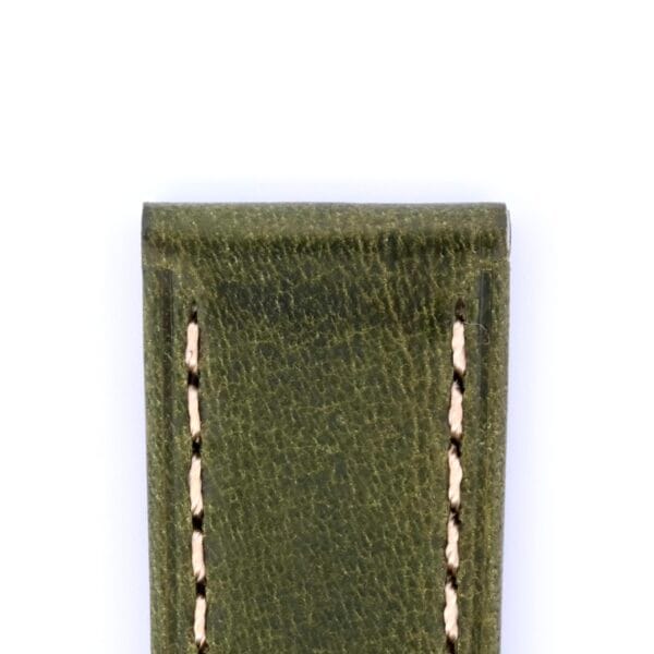 A close-up of the top section of a Simple Stitch Vintage Leather Watch Strap Matte Finish in green leather with visible edge stitching, set against a white backdrop.