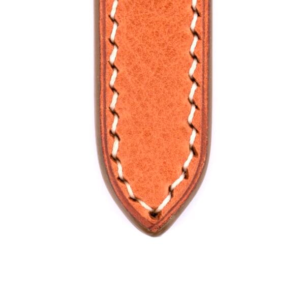 Close-up image of a Light Brown Buttero Leather Handmade Watch Strap with white stitching. The pointed end is displayed on a crisp white background, highlighting its artisanal craftsmanship.