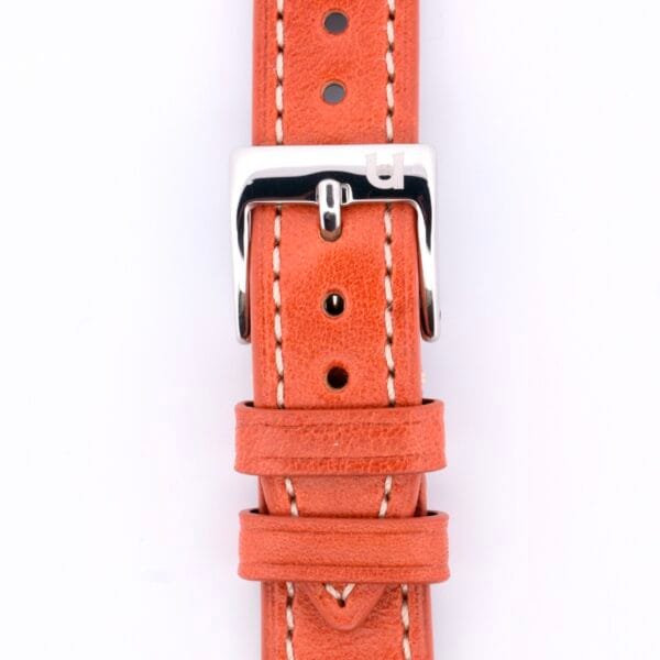 Close-up of the Simple Stitch Classic Leather Watch Strap, crafted from vintage orange leather with white stitching. It has a silver u-adorned buckle and several adjustment holes, enhancing its timeless charm.