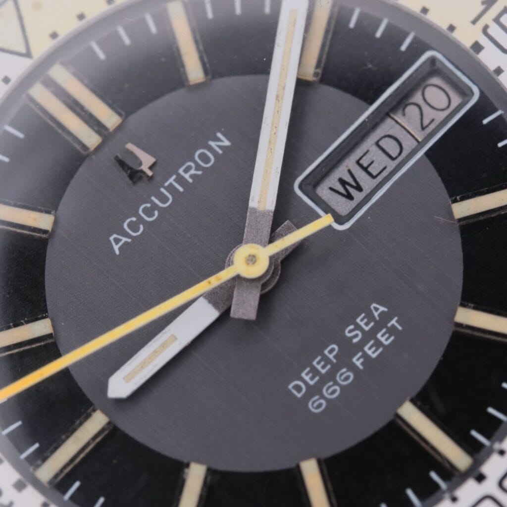Close-up of a vintage Bulova Accutron Deep Sea 666 “Devil Diver” Inner Bezel watch with a black dial, gold and white hour markers, luminous hands, and a date window showing WED 20.