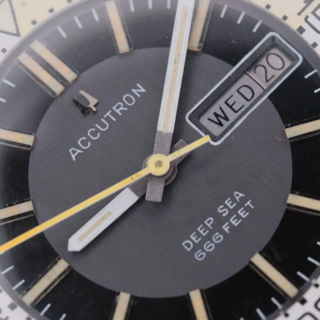 Close-up of a vintage Bulova Accutron Deep Sea 666 “Devil Diver” Inner Bezel watch with a black dial, gold and white hour markers, luminous hands, and a date window showing WED 20.