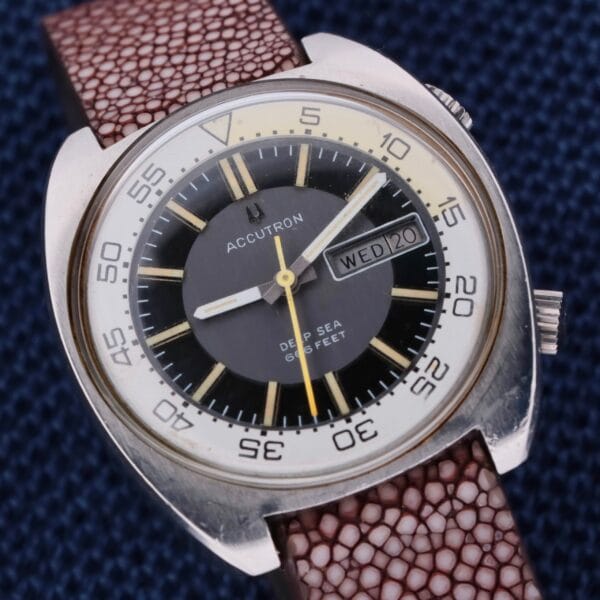 The vintage Bulova Accutron Deep Sea 666 Devil Diver Inner Bezel watch features a brown leather strap, displays “WED” and “20,” and showcases a black and white dial with a rotating bezel marked in increments of 10.
