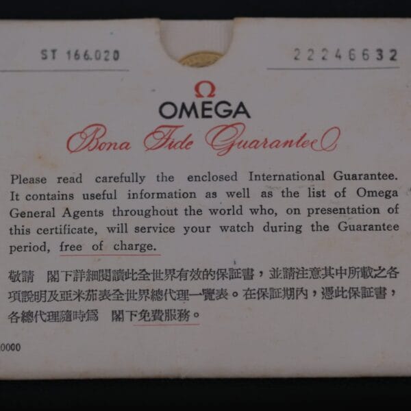 A close-up of an Omega warranty card marked Bona Fide Guarantee details international coverage for products, including the Omega Seamaster Deville Automatic for the Japanese Market, offering complimentary service in English and Chinese during the warranty period.