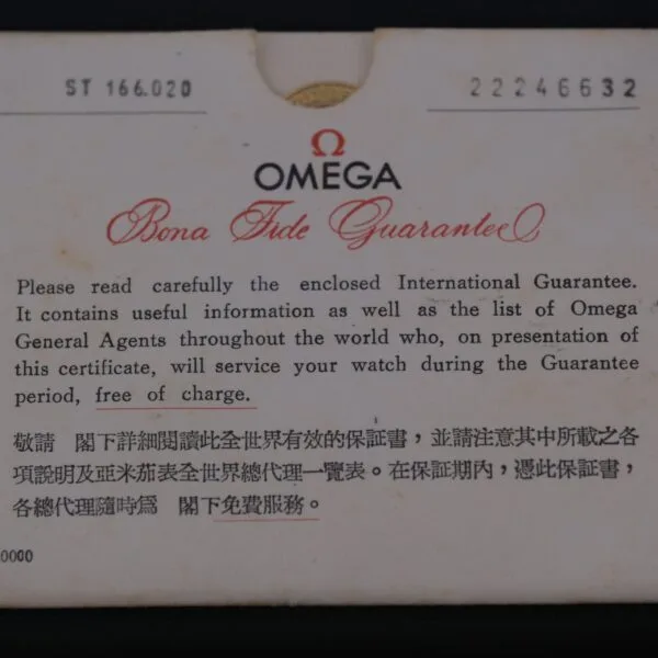 A close-up of an Omega warranty card marked Bona Fide Guarantee details international coverage for products, including the Omega Seamaster Deville Automatic for the Japanese Market, offering complimentary service in English and Chinese during the warranty period.