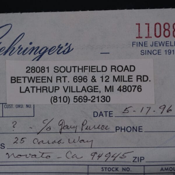 Close-up of a paper receipt from Lehringers Fine Jewelry at 28081 Southfield Road, Lathrup Village, MI, with handwritten sections for date, recipient, and address. Dated 5-17-96, it notably mentions an Omega Seamaster Deville Automatic For Japanese Market.