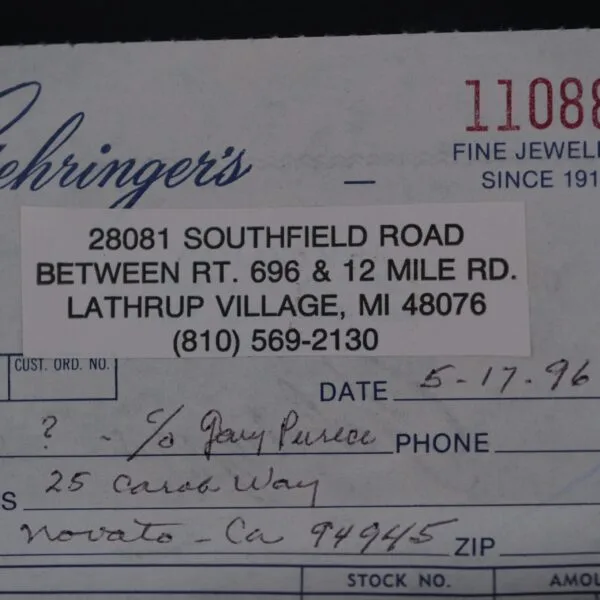 Close-up of a paper receipt from Lehringers Fine Jewelry at 28081 Southfield Road, Lathrup Village, MI, with handwritten sections for date, recipient, and address. Dated 5-17-96, it notably mentions an Omega Seamaster Deville Automatic For Japanese Market.