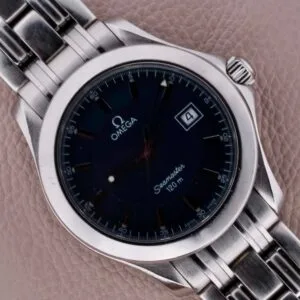 Close-up of an Omega Seamaster 120M Blue Wave with a dark face and silver bracelet, featuring a date window; it rests elegantly on a tan leather surface.