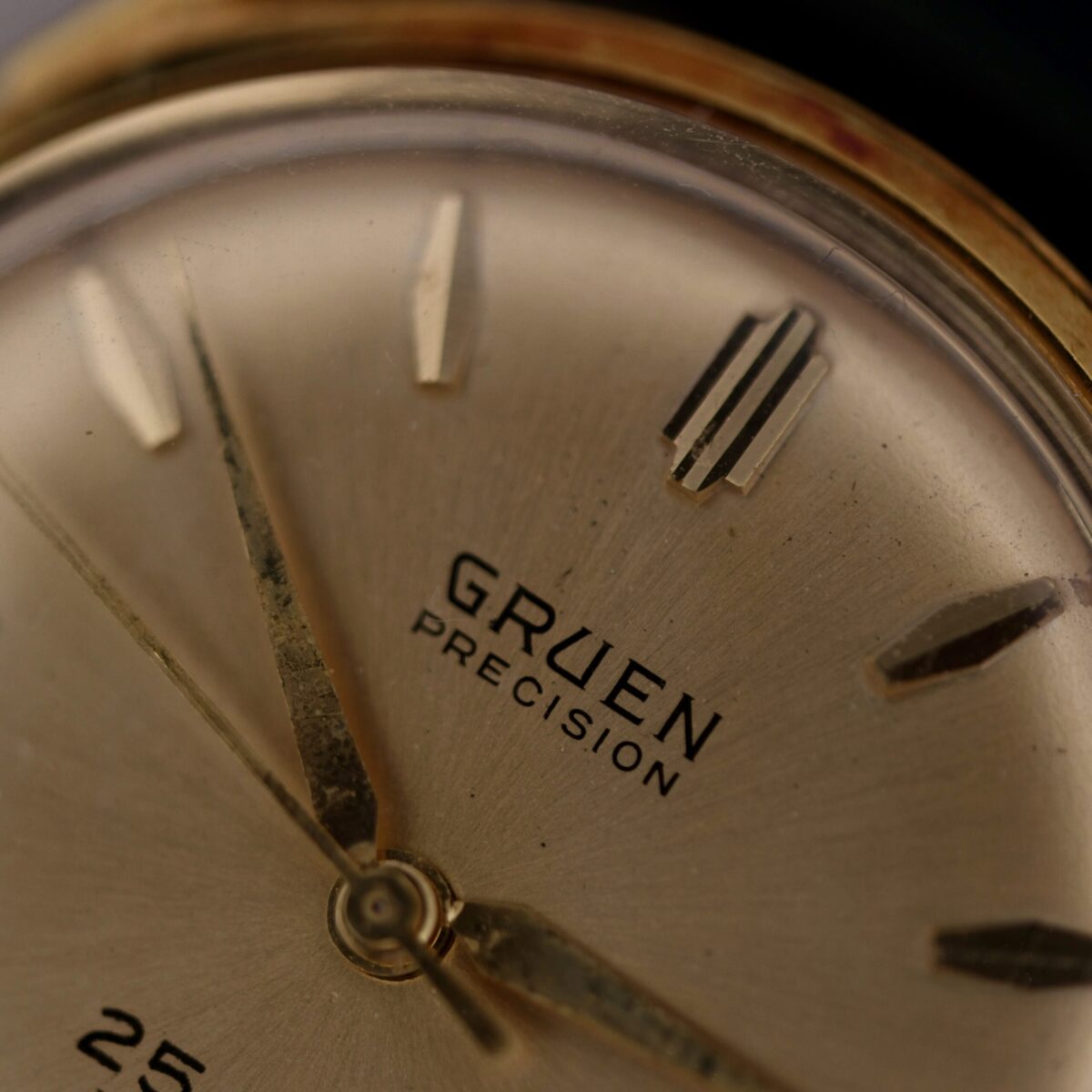 Introducing the exquisite 1960s Gruen Precision 25 Jewels Auto Wind with Bombay Lugs, a timeless masterpiece that embodies the elegance and craftsmanship of Swiss watchmaking. This vintage timepiece, hailing from the golden era of the 1960s, is a testament to Gruen's dedication to precision and style.

The watch features a robust automatic movement with 25 jewels, ensuring accurate timekeeping and a smooth, reliable performance. The case, crafted from high-quality gold plate and stainless steel, measures a classic 34mm in diameter, making it a perfect fit for any wrist. The distinctive Bombay lugs add a touch of sophistication and uniqueness to the design, setting it apart from other vintage watches.

The dial is a refined beige color, complemented by sleek black and gold accents that enhance its readability and aesthetic appeal. The central seconds hand provides a precise and elegant way to track time, while the absence of a date function maintains the watch's clean and uncluttered look.

This Gruen Precision watch is paired with a luxurious leather strap, offering both comfort and durability. The 18mm width of the strap ensures a secure and stylish fit, making it suitable for both formal and casual occasions.

Embrace the charm and heritage of Swiss watchmaking with the 1960s Gruen Precision 25 Jewels Auto Wind Bombay Lugs. This exceptional timepiece is not just a watch; it's a piece of history that will elevate any collection.