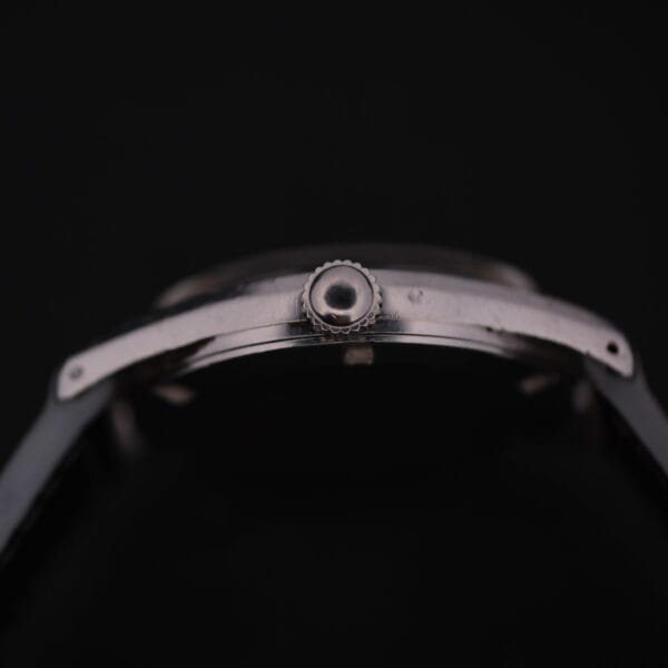Close-up of a Certina DS 1st Gen Cal. 25-36 Stainless Steel wristwatch with a black band, showcasing the side view of the case and crown against a dark background.