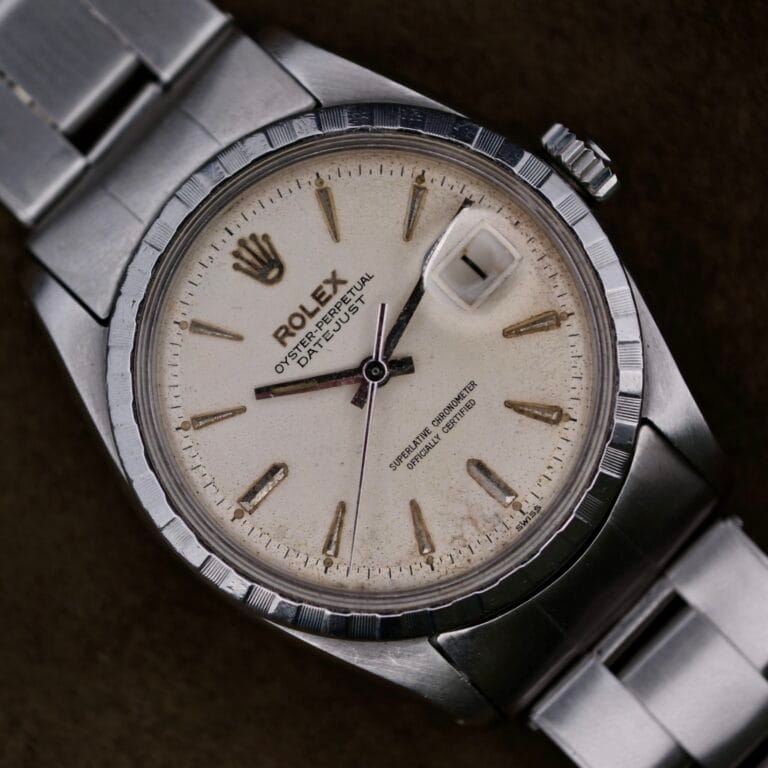 The Rolex Oyster Perpetual Datejust 6605 Cal. 1066 exudes timeless elegance with a stainless steel band, white dial, and gold hour markers. The date window at 3 oclock complements its vintage charm, while the aged face narrates stories of decades well-traveled.