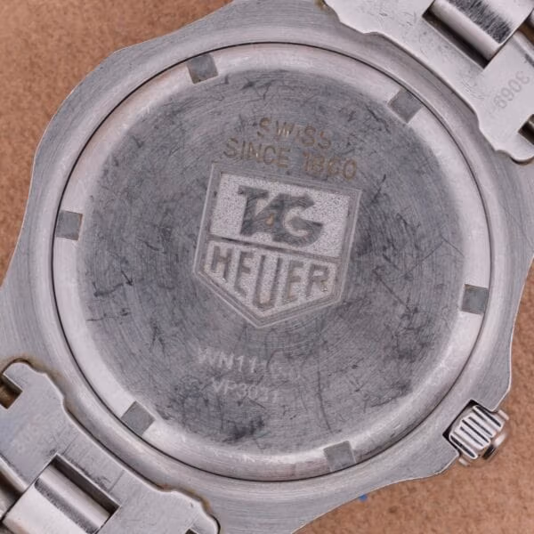 Caseback of TAG Heuer Professional Dive WN1110-0 with SWISS SINCE 1860 engraving above the TAG Heuer shield logo and reference WN1110-0 stamping