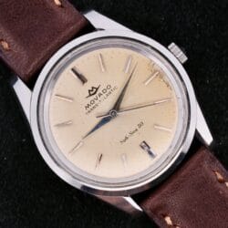 The Movado Trans-Atlantic Sub Sea 50 is a vintage watch with a beige dial and brown leather strap.