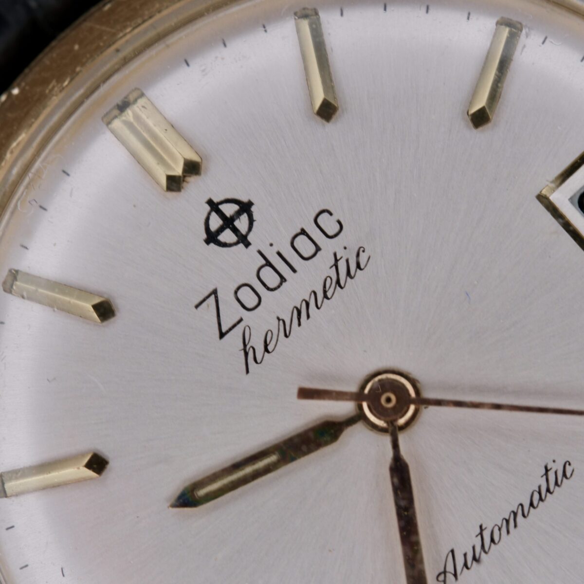 Introducing the Zodiac Hermetic 14k Gold Automatic Date, a timeless masterpiece from Switzerland, crafted between 1960 and 1969. This exquisite timepiece features a 34mm 14k gold case, a sleek silver dial with gold hour markers and hands, central seconds, and a date function. Powered by an automatic movement, it ensures precise timekeeping. The 18mm leather strap offers comfort and security. This watch embodies elegance and functionality, making it a must-have for discerning collectors and enthusiasts.