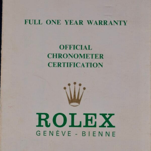 A beige card with green text reads: Full one year warranty, official chronometer certification. Below is a gold crown symbol and the green text Rolex Genève - Bienne. Experience timeless elegance with the Rolex Oyster Perpetual Date 1500 Blue Dial.