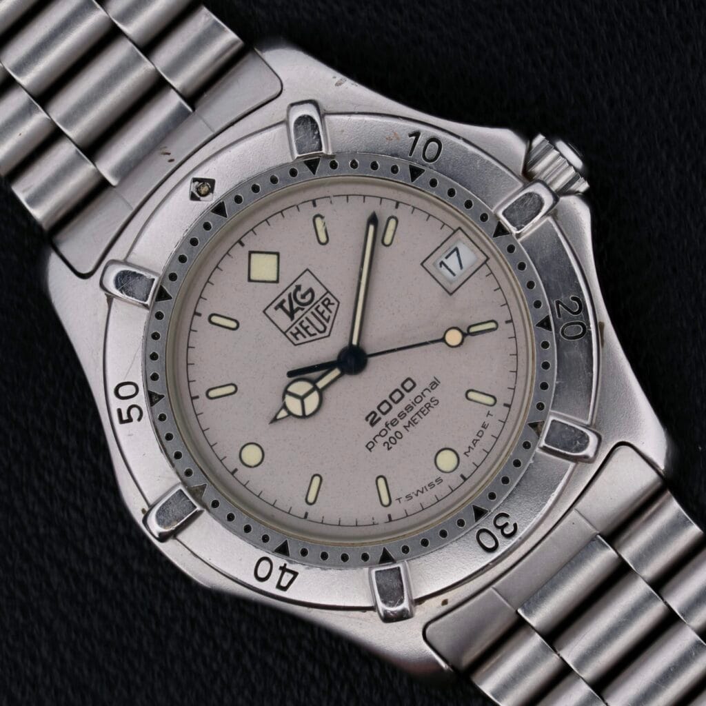 A Tag Heuer Professional 2000 Dive wristwatch with a silver metal band, round bezel, and date set to the 17th.