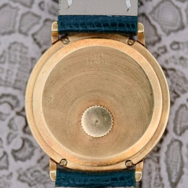 A gold watch with a blue strap