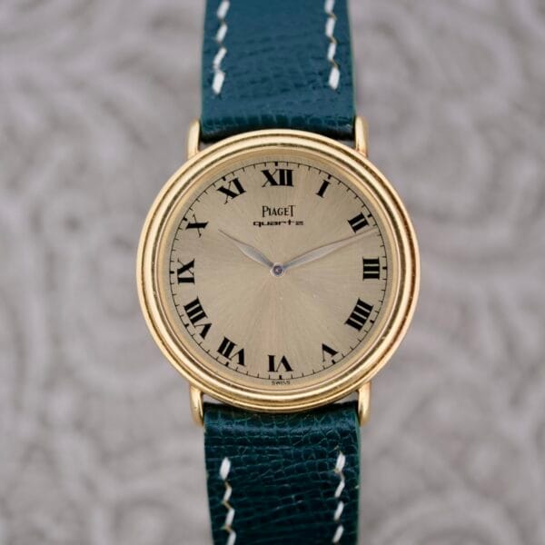 A watch with a green strap