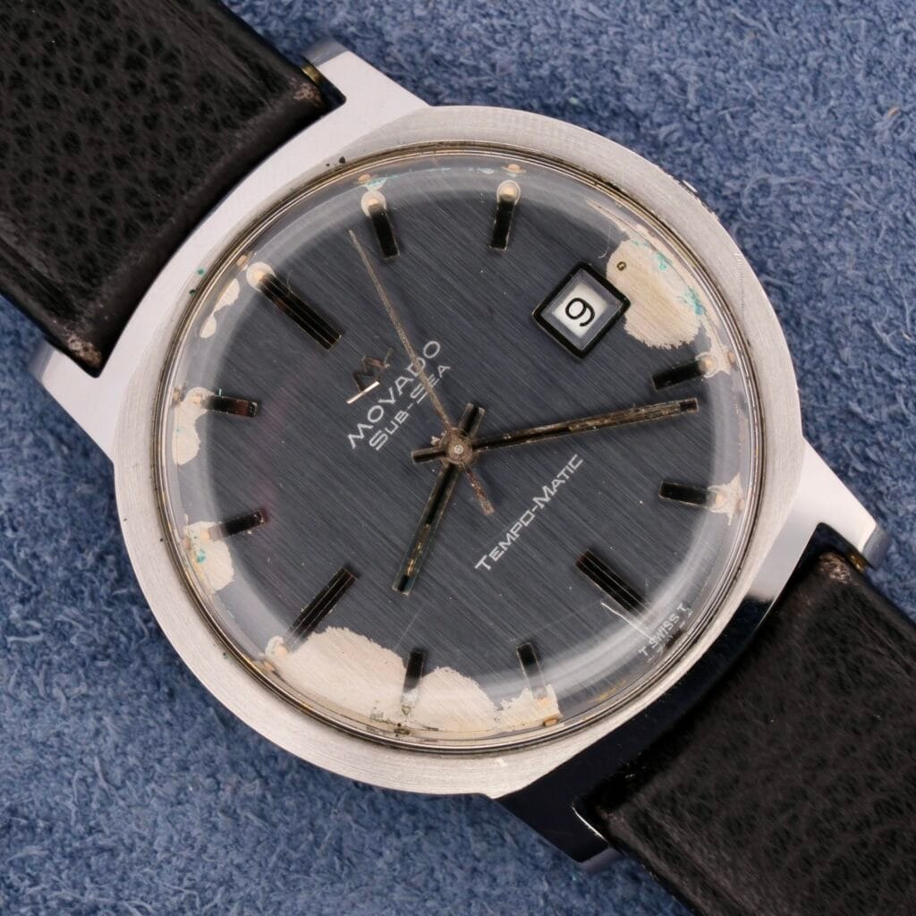 A vintage Movado Sub-Sea Tempomatic Date watch with a black leather strap, visible wear on the face, and the date set to 9.