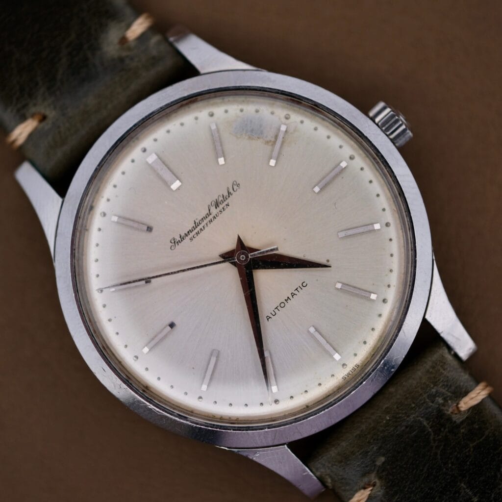 A 1960s IWC Automatic Dress Watch, featuring the renowned Cal. 853 movement, a sleek silver case, and leather strap, displaying the time 7:22.