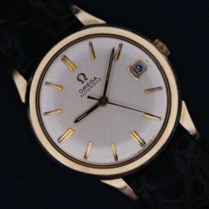 1966 Omega Automatic Date Cal. 563 wristwatch featuring a white dial, black leather strap, and date displayed as the 19th.