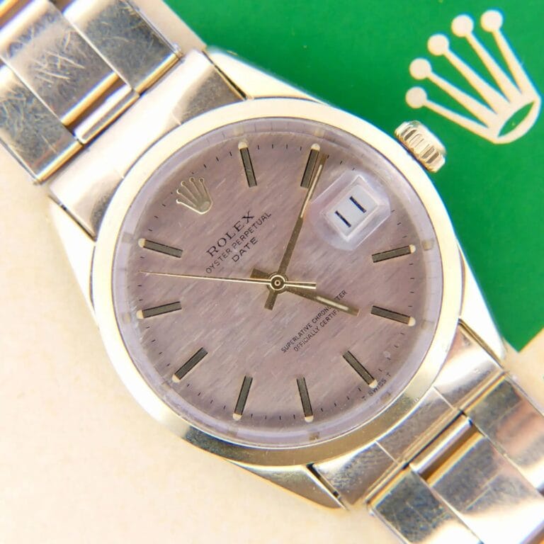 A close-up of a 1978 Rolex 1550 Oyster Perpetual Date 14k Gold Shell wristwatch with a date display and the Rolex logo on a green background.