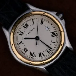 Cartier Cougar Gents Date Ref. 187904 wristwatch featuring classic Roman numerals, gold bezel, black leather strap, and date window positioned at 4 oclock.