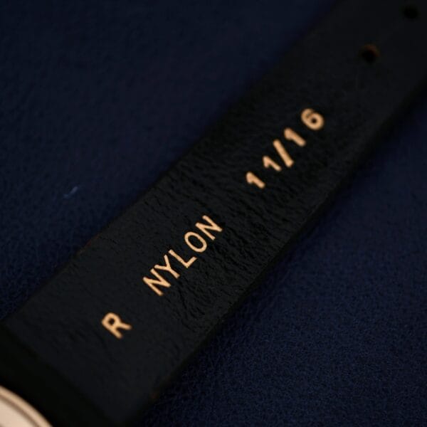 A black wristwatch with gold text