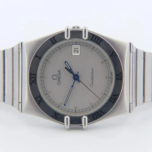 The Omega Constellation Ref. 396.10701 features a stainless steel case, silver dial with black Roman numerals, blue hands, date window at 3 o’clock, and is shown on a matching silver metal bracelet.