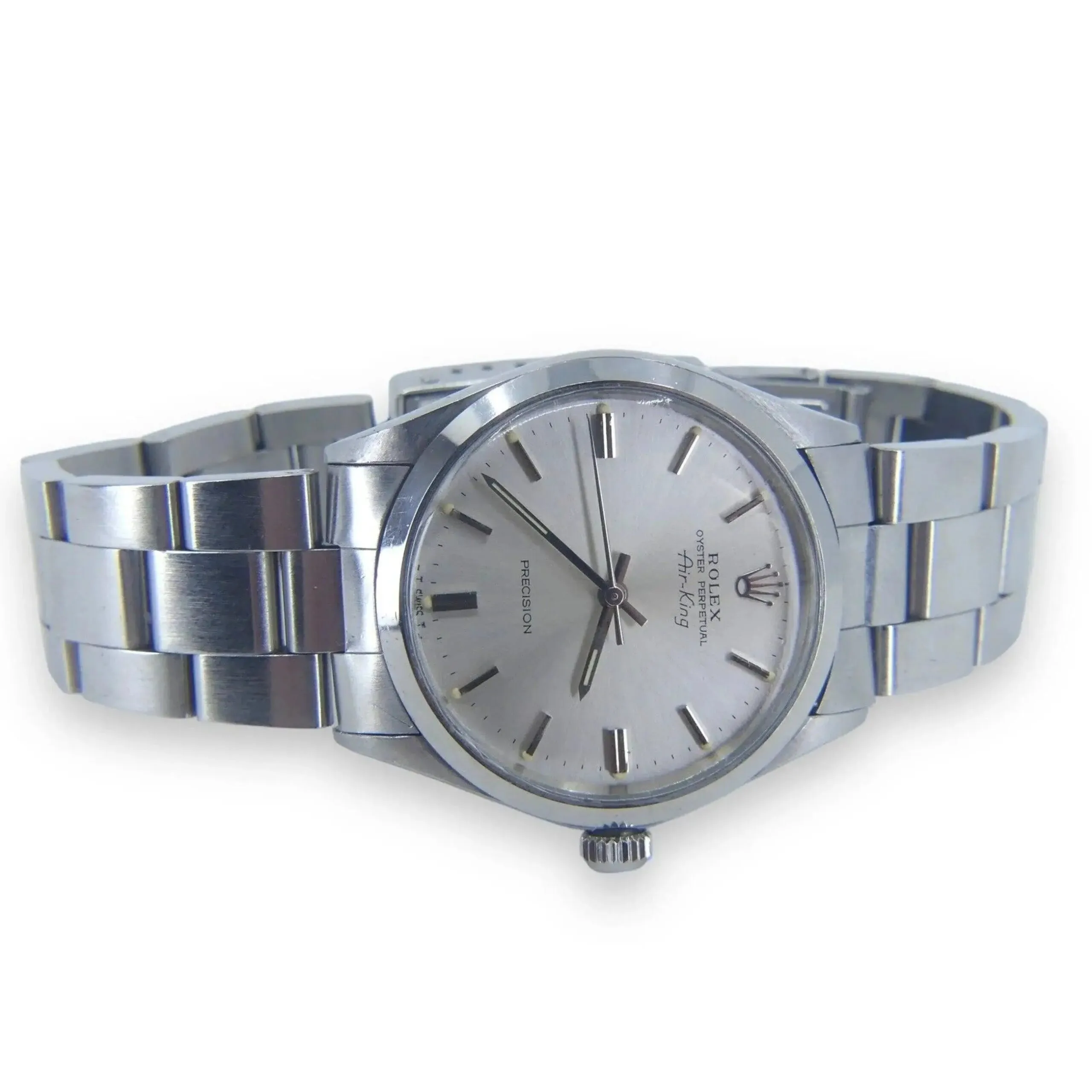 The Rolex Air King Precision 5500 is a mens stainless steel wristwatch with a silver dial and minimalist hour markers. It features a metal link bracelet, centered winding crown, sleek hour and minute hands, and a subtle second hand.