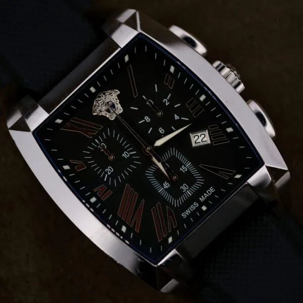 A close-up of the Versace Character Tonneau Swiss Made Chronograph, featuring a black tonneau case, textured strap, Roman numerals, and a date display.