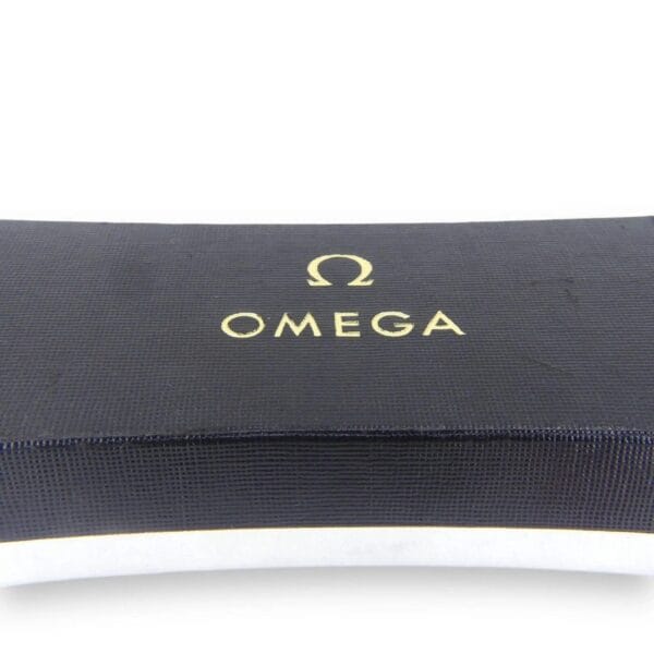 A close-up image of the Vintage Omega Continental Can box shows the gold-printed Omega logo and brand name on a textured, curved black surface with a smooth, clean appearance.